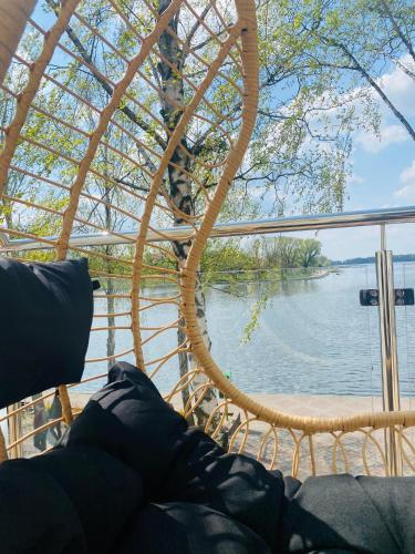 a view of the water from the porch of a boat at Apartament MoLoo I in Ostróda