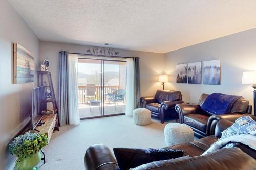 a living room with leather furniture and a sliding glass door at Relaxation Pointe in Branson