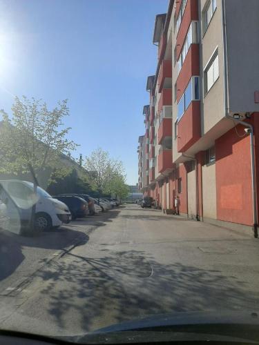 a street with cars parked next to a building at Maki & Dare Apartment Ilidza in Sarajevo