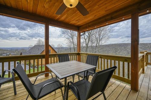 a wooden deck with a table and chairs on it at Curb-Free Chalet in McHenry