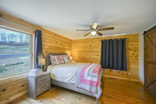 a bedroom with a bed and a ceiling fan at Curb-Free Chalet in McHenry