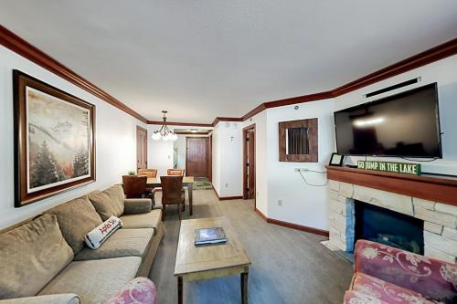 a living room with a couch and a fireplace at Resort at Squaw Creek's 319 in Olympic Valley