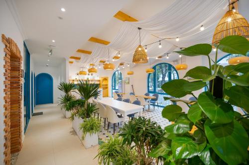 a room with plants and a table and chairs at Santori Hotel And Spa in Da Nang
