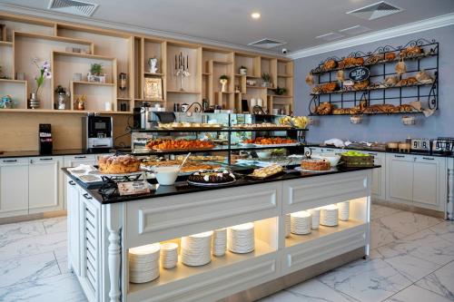 a large kitchen with a buffet of food at Casa di Fiore SPA and Medical Hotel, Mineral Pools & Private Beach in Kranevo