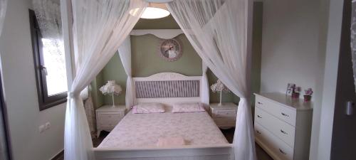 a bedroom with a bed with a canopy at Seaside Boutique Villa in Volos