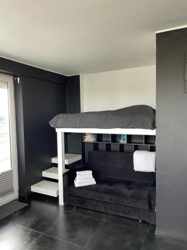 a bedroom with a bunk bed and a couch at GreatView in Warsaw