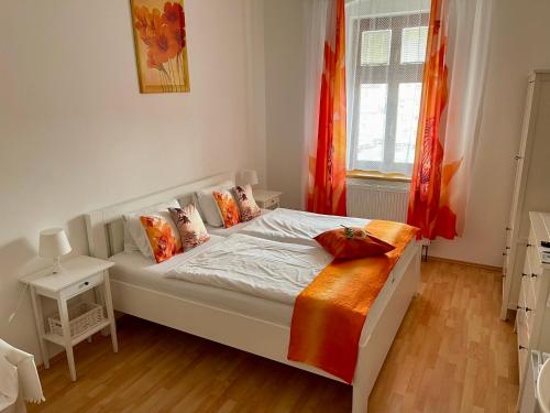 a white bed in a room with a window at Penzion u Vlčků in Cheb