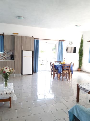 a kitchen and dining room with a table and chairs at Artemis Apartments in Almyrida
