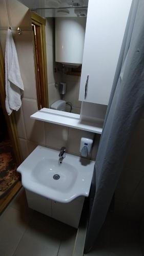 a bathroom with a white sink and a mirror at Brvnara Fairy Tale in Cetinje