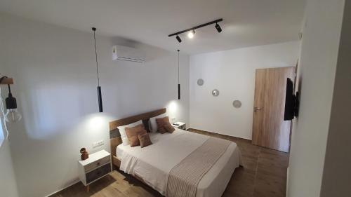 a bedroom with a bed in a white room at Elizabeth Suites in Kato Daratso