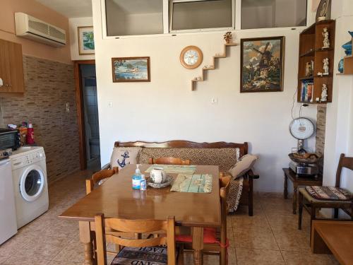 a kitchen and living room with a table and a stair at Modern 1-bedroom with BBQ & Roof Garden near Beach in Stalos