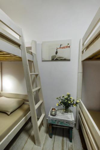 a small room with two bunk beds and a table at Kalimera & Apoplous boathouse in Klima