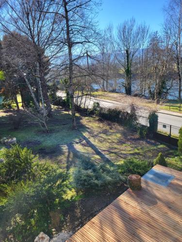a view of a park with trees and a bench at Gîte PRAT NAOU - PYRENNEES ARIEGEOISES in Taurignan-Vieux
