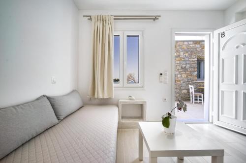 a living room with a couch and a table at Anius Apartments in Mýkonos City