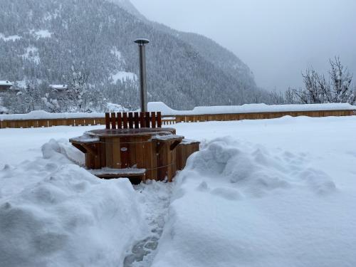a pile of snow next to a wooden fence at Chalet des Trappeurs Coeur Vanoise 15 persons in Champagny-en-Vanoise