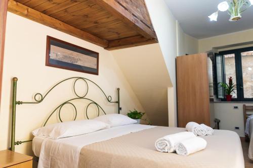 タオルミーナにあるVico Tauro Houseのベッドルーム1室(ベッド1台に白いタオル2枚付)