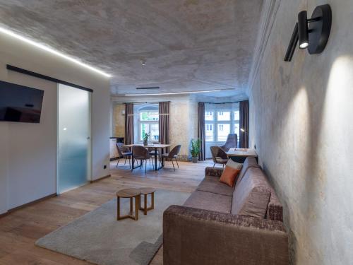 a living room with a couch and a table at Platzhirsch Kufstein in Kufstein