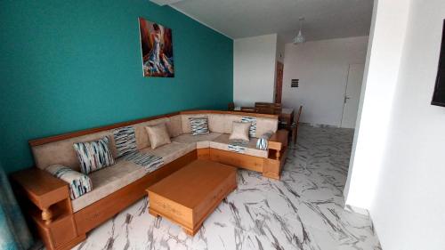a living room with a couch and a green wall at Pride of Kelibia in Kelibia