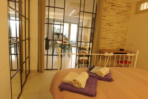 a bedroom with a bed with two towels on it at BALATA home in Marina di Ragusa