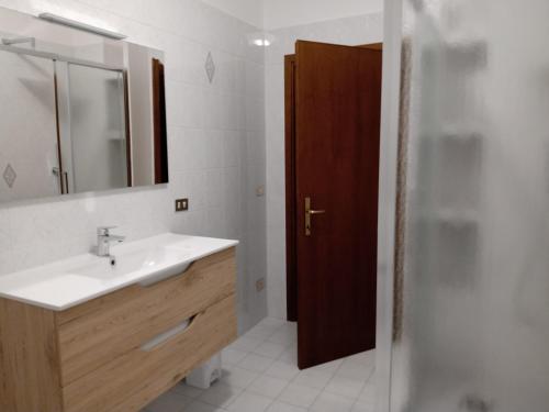 a bathroom with a sink and a mirror and a shower at La Fondona in Campagnatico