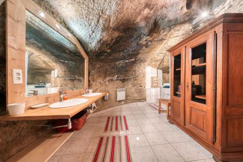 a large bathroom with two sinks and a stone wall at Luberon maison de village entière 2 à 6 personnes in Cabrières-dʼAigues