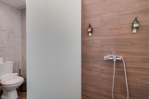 uma casa de banho com WC e luzes na parede em Monastiraki #509 by SuperHost Hub em Atenas