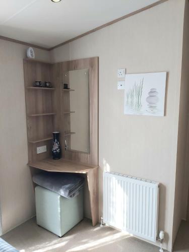 a bathroom with a sink and a mirror in a room at Vista Al Mar, Seaview Caravan Park, Whitstable in Kent