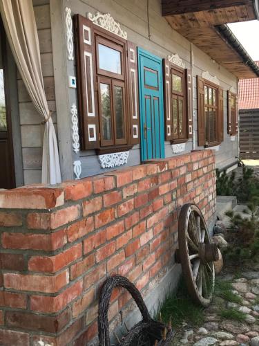 a brick wall in front of a house at Zagroda w Puszczy in Białowieża