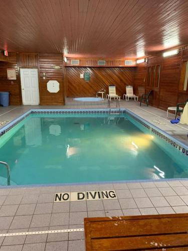 a large swimming pool with a no diving sign in it at Days Inn by Wyndham Topeka in Topeka