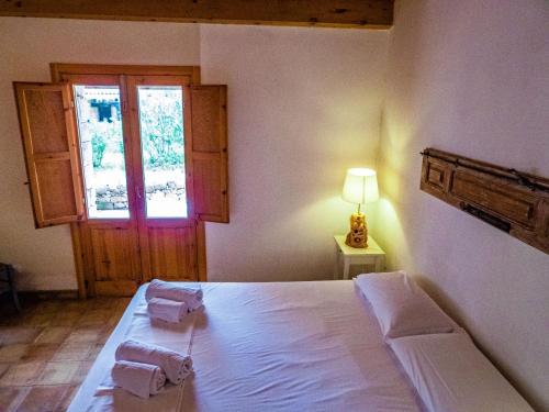 a bedroom with a bed with two towels on it at Casa Bedda in Noto Marina