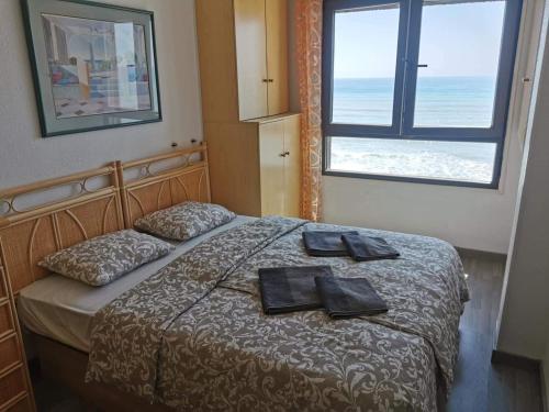 a bedroom with a bed with two towels on it at Playa apartamento in Torrevieja