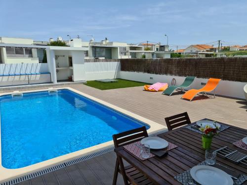 a swimming pool on the roof of a house at Meco Beach Villa in Sesimbra
