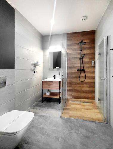 a bathroom with a shower and a toilet and a sink at Kamienica Morska Gdynia in Gdynia