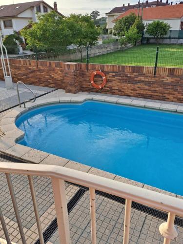 a large blue swimming pool in a yard at Benedicto in Ajo