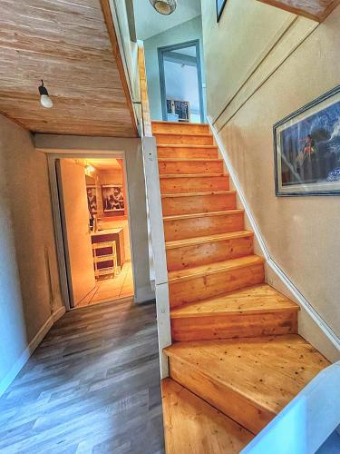 a staircase in a house with wooden floors at Ti Kaz Auberge in Saint-Just