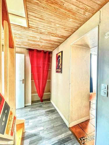 a room with a red curtain and a door at Ti Kaz Auberge in Saint-Just