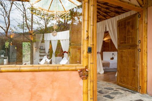 an open door to a bedroom with a bed at Chalets HUITACA in Choachí