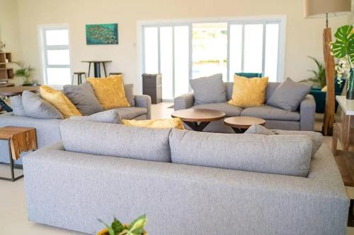 a living room with two couches and a table at Hamilton @ Oceanpointe a serene 2bed 2 bath Villa in Lucea