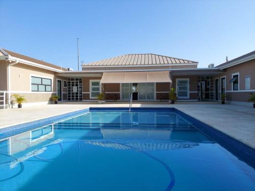 a swimming pool in front of a house at Hamilton @ Oceanpointe a serene 2bed 2 bath Villa in Lucea