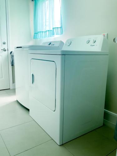 a white washer and dryer in a kitchen at Hamilton @ Oceanpointe a serene 2bed 2 bath Villa in Lucea