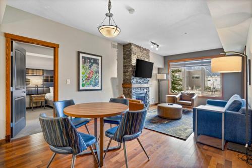 a living room and dining room with a table and chairs at Stoneridge Mountain Resort Condo managed by Little Sister Getaways in Canmore
