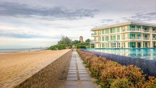 a building on the beach next to the ocean at On-the-Beach Seaview With Direct Pool Access - 1 Bedroom by Sweethome in Ban Bo Khaem