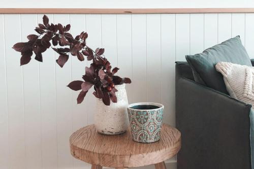 a vase sitting on a table next to a couch at Joy Apartment 3 in Lorne