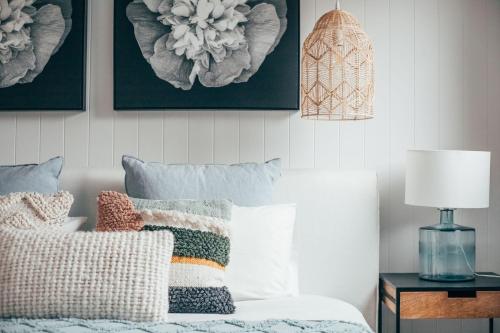 a bedroom with a bed with pillows and a lamp at Joy Apartment 3 in Lorne