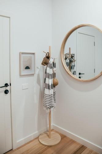 a mirror hanging on a wall next to a hallway at Joy Apartment 3 in Lorne