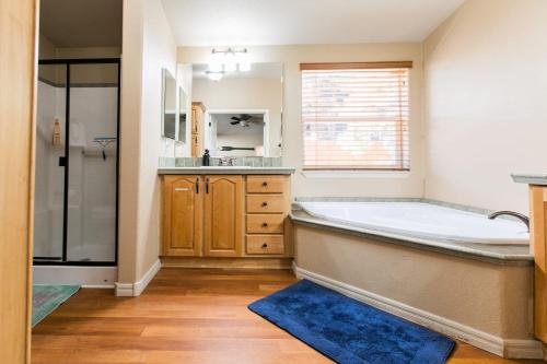a large bathroom with a tub and a sink at Whispering Pines - Big Bear Lake in Big Bear Lake