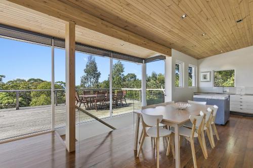 a kitchen and dining room with a table and chairs at Kiara in Lorne