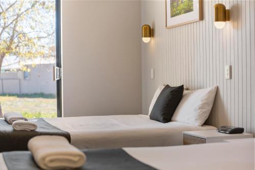 Ένα ή περισσότερα κρεβάτια σε δωμάτιο στο The Wine Vine Hotel