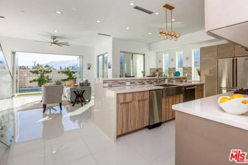 a kitchen with white countertops and a dining room at Gateway Luxury Resort Style With A Private Pool in Palm Springs