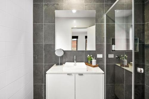 a bathroom with a white sink and a mirror at Chatleys in Aireys Inlet